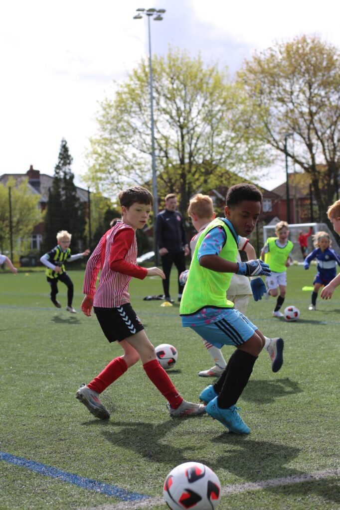 Two young players challenging for the ball