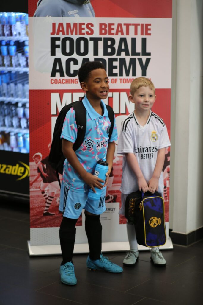 Two young players at a James Beattie Football Academy event