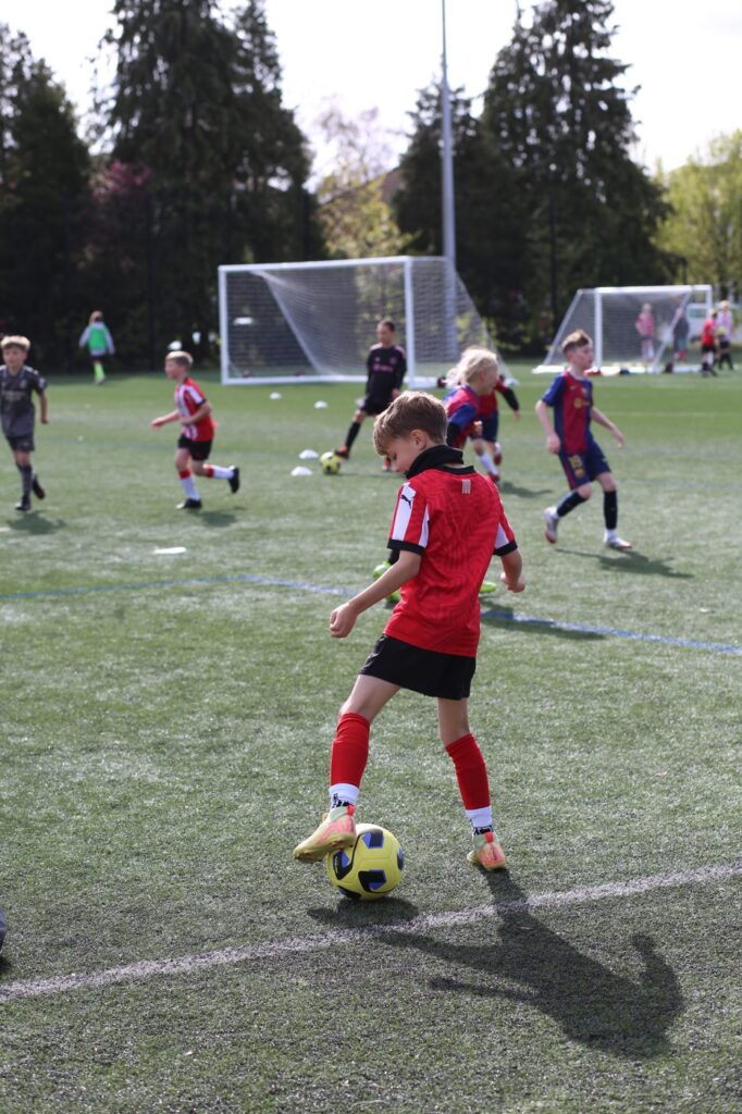 A young player striking the ball