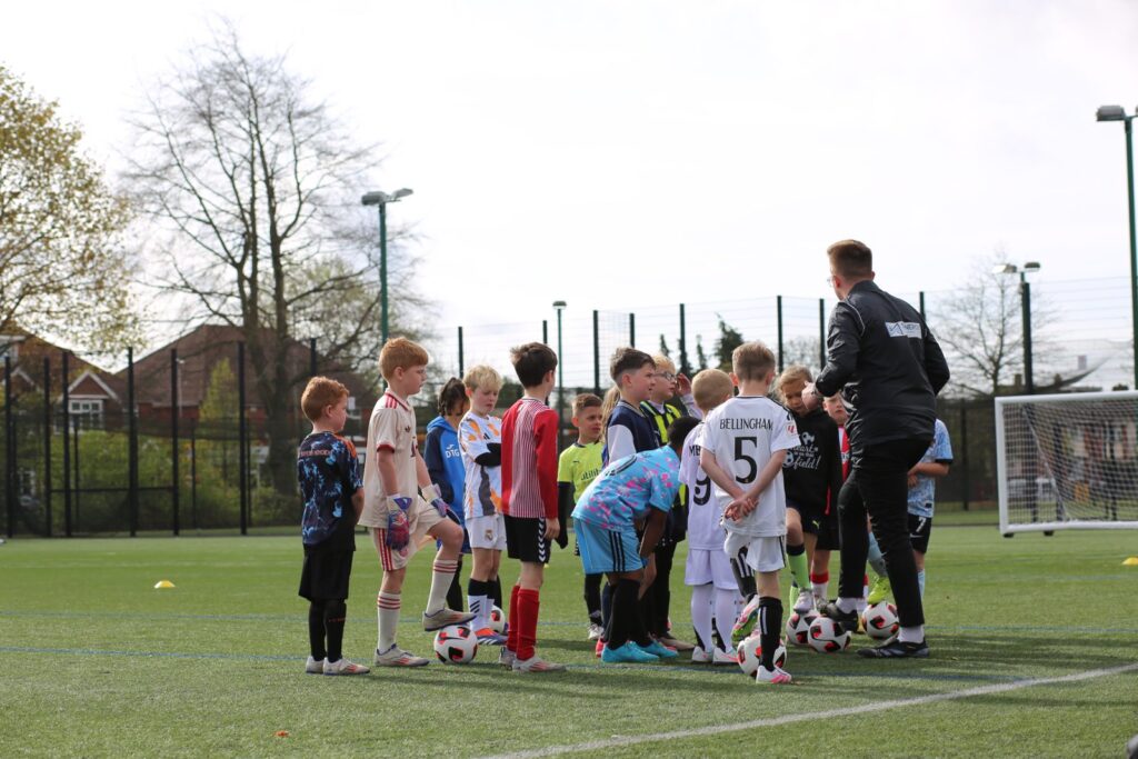 Young players gathered around a coach