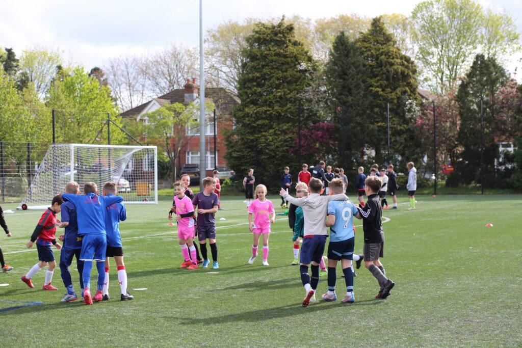 Children running with the ball at a holiday camp