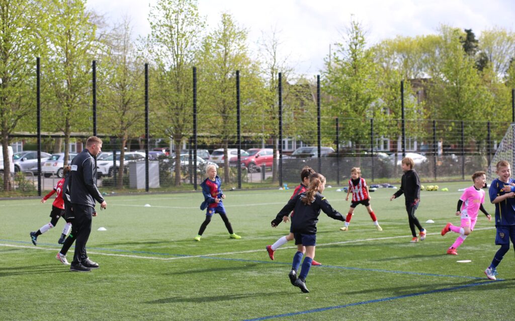 Children playing football at a holiday camp